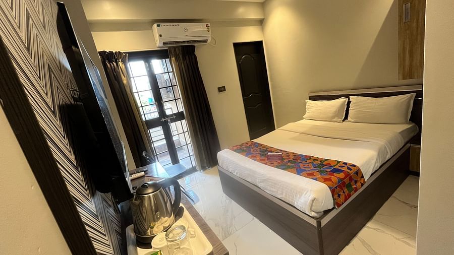 A hotel bedroom with a large bed in front of a wall mounted television and a wall mounted air-conditioner - VITS Select Kharadi, Pune