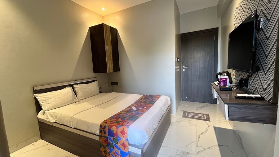 A hotel bedroom with ambient light brightening up the room at VITS Select Kharadi, Pune.