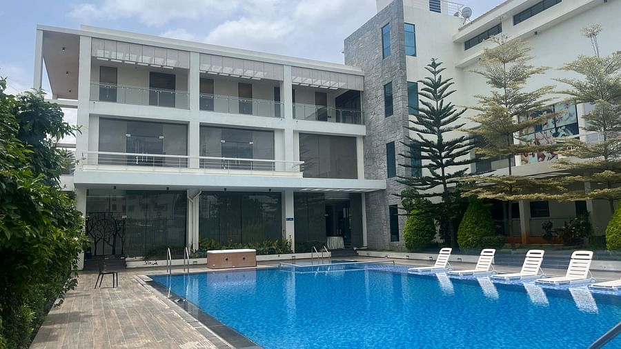 An inviting swimming pool surrounded by a modern property, ideal for leisure.