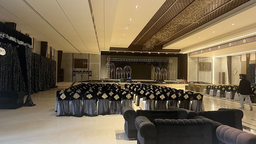 Spacious banquet hall with seating arrangements and marble flooring
