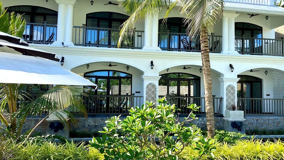 trees and bushes in front of balconies at Lagoon De Pondy