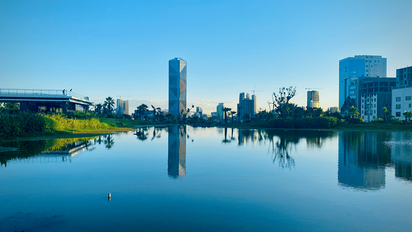 Addis Ababa under a clear sky with its reflection on undisturbed water mirroring the nearby buildings, offering the best time to visit Ethiopia