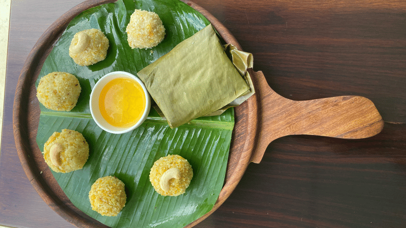 Platter of cheenikaayi kadabu ona banana leaf with a dipping sauce 