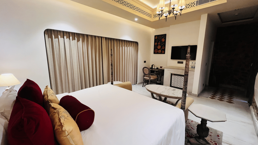Premium Deluxe Room bedroom at Juna Mahal, Ranthambore with plush bedding, warm lighting, classic décor and spacious layout for a luxurious stay