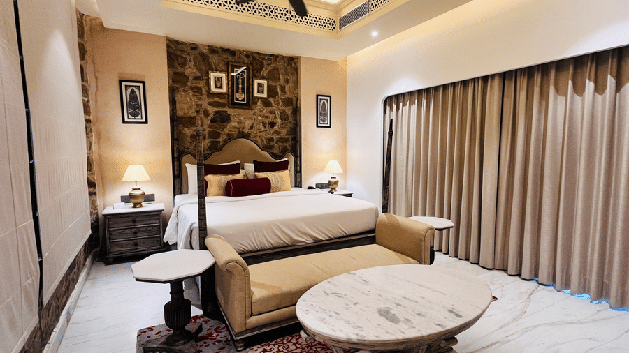 Premium Deluxe Room living area at Juna Mahal, Ranthambore with elegant seating, marble flooring, décor accents and spacious ambiance