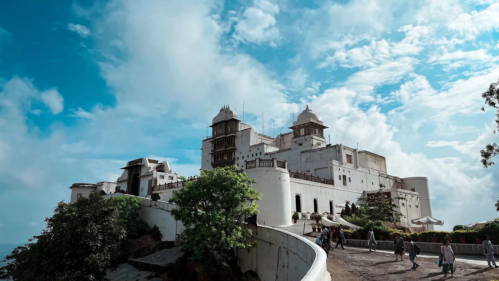 A building with towers sits atop a hill.