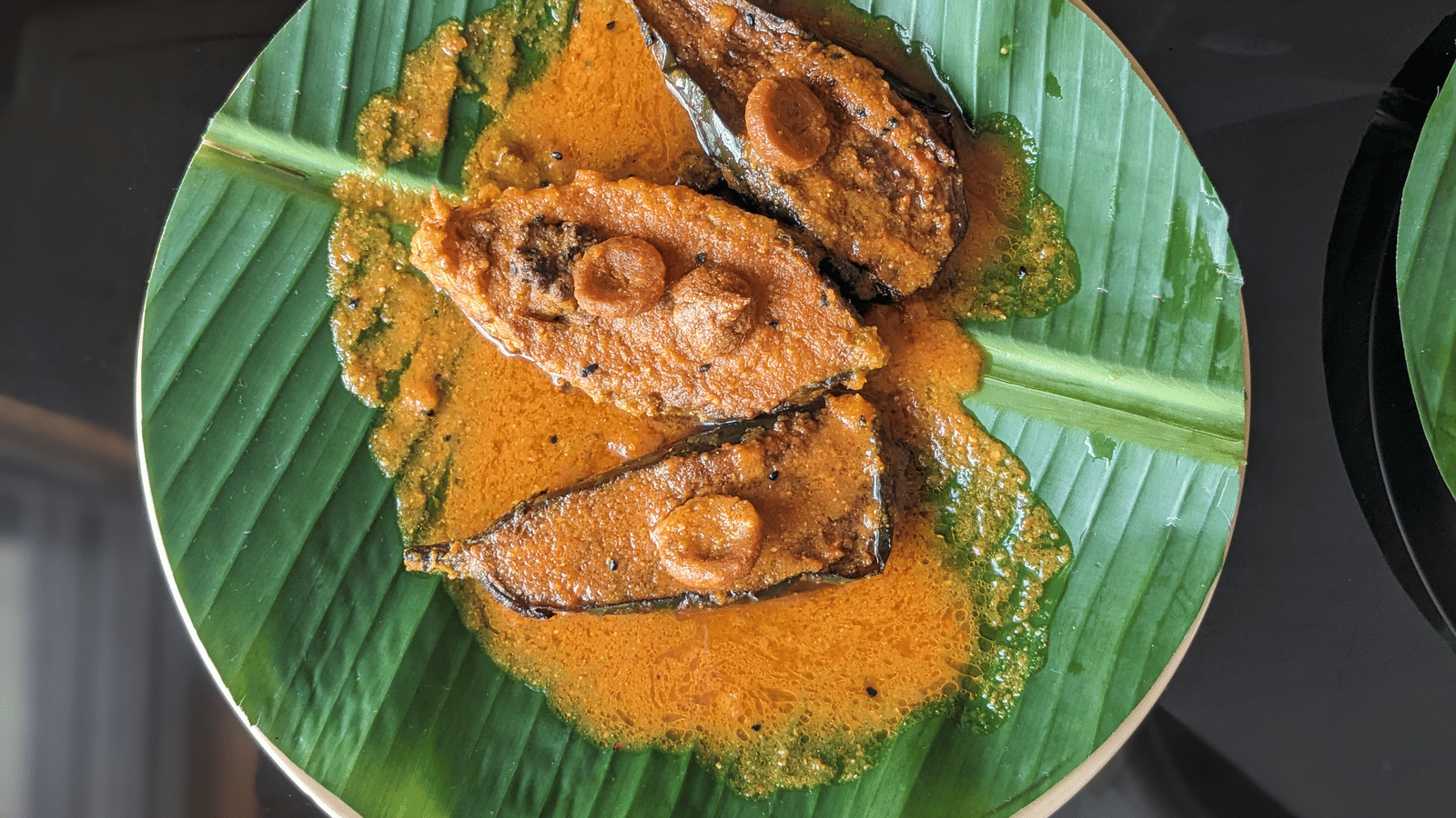 A delicacy made of fish, plated on a circular plantain leaf at Dip Holidays