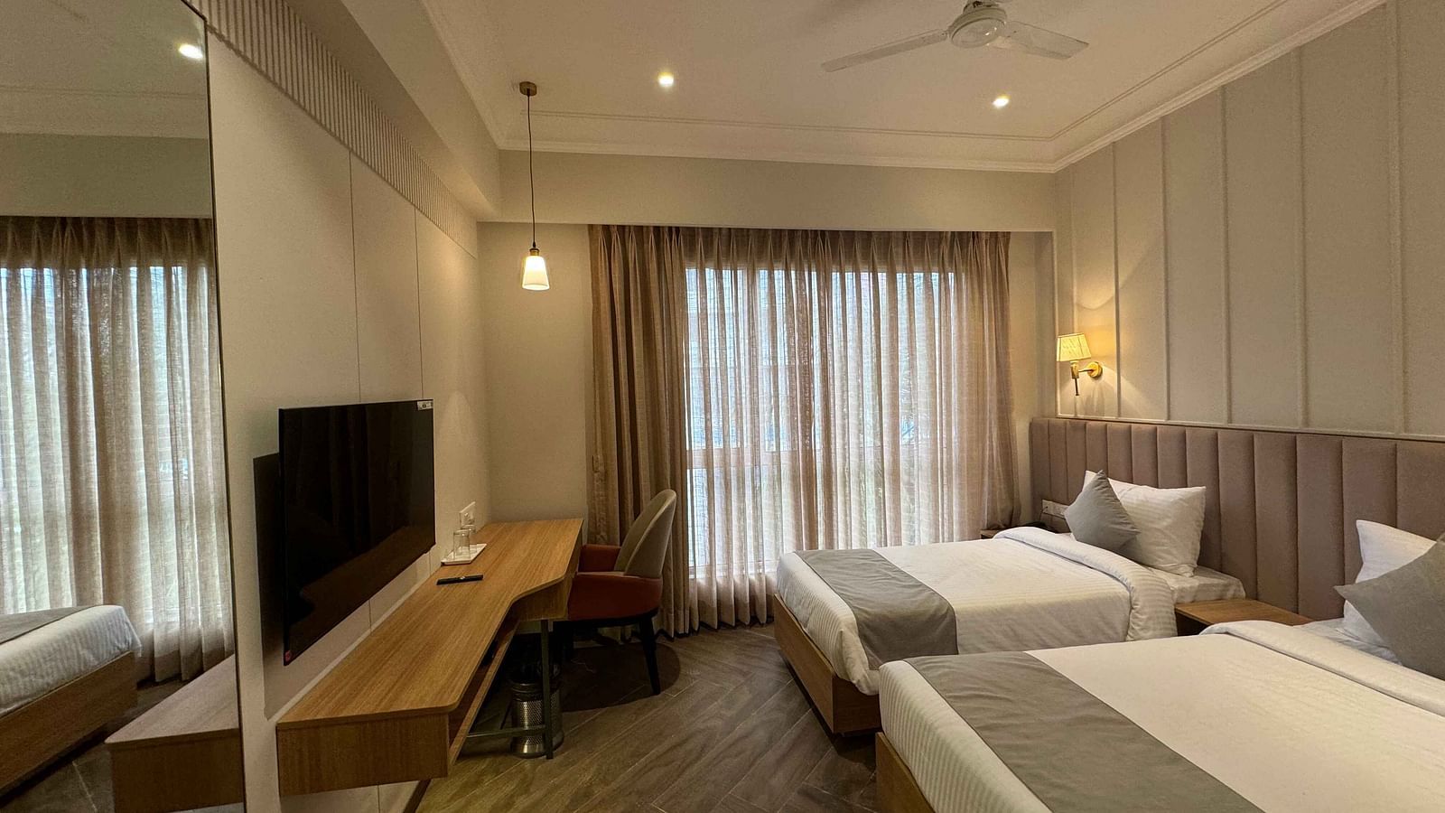 side view of the twin bedroom with a television  Hotel Mumbai House Mindspace Malad