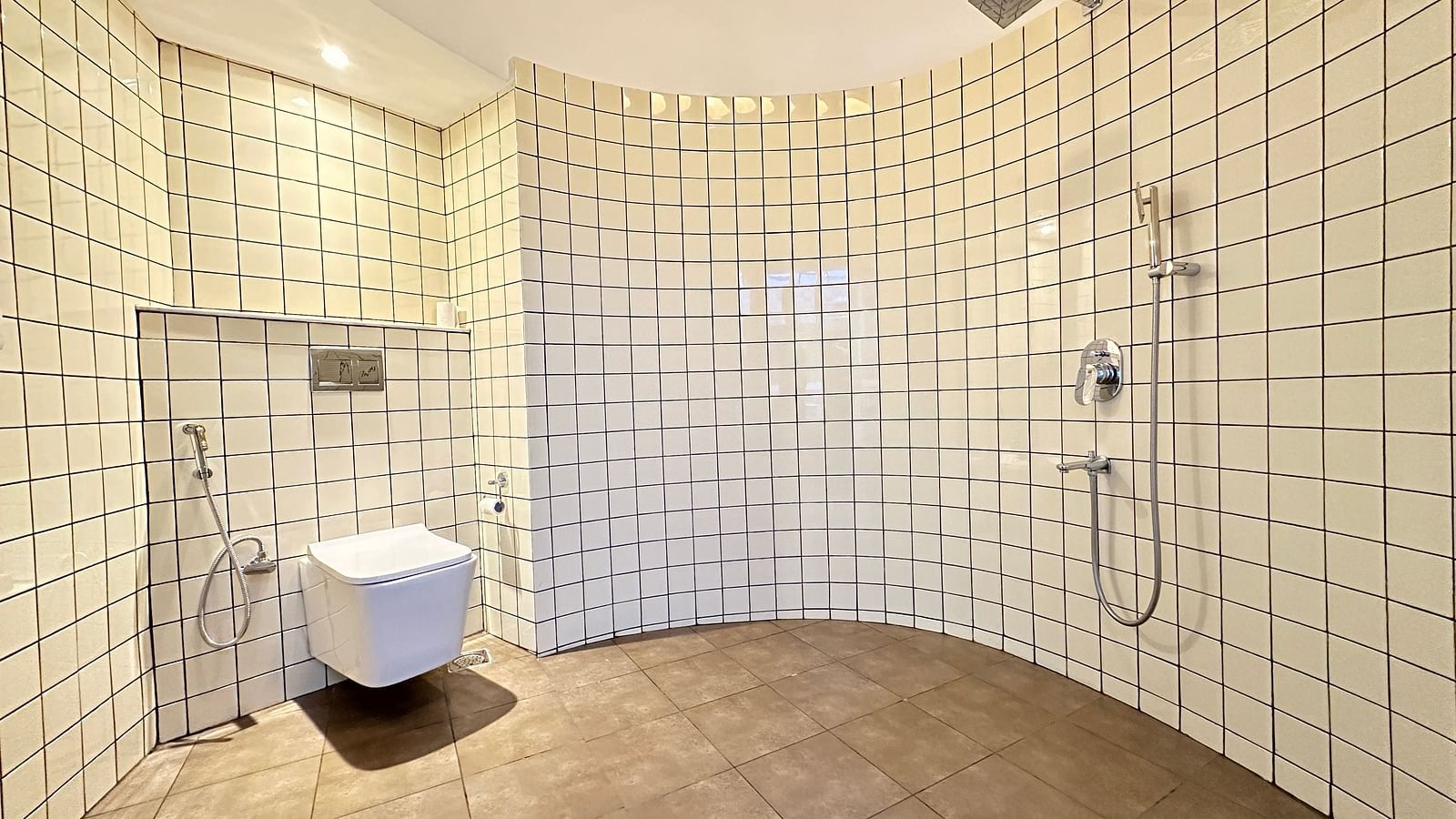 a bathroom with a western style toilet and a shower - Kadkani River Resort, Coorg