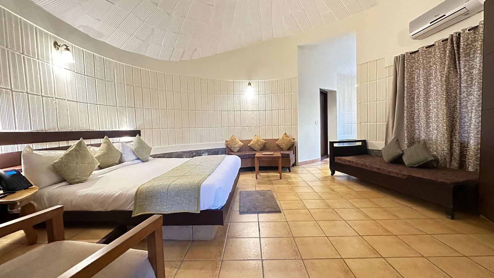 a bedroom with a double bed and a single bed opposite to it, with chairs in the room - Kadkani River Resort, Coorg