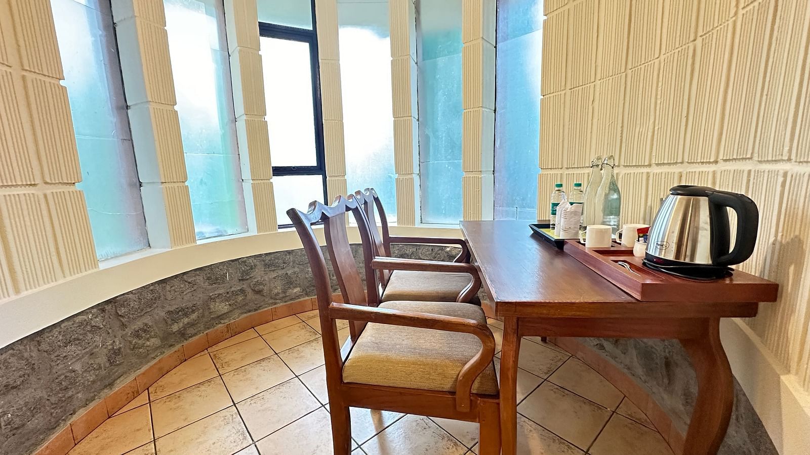 a workdesk with a tea kettle and chairs  - Kadkani River Resort, Coorg