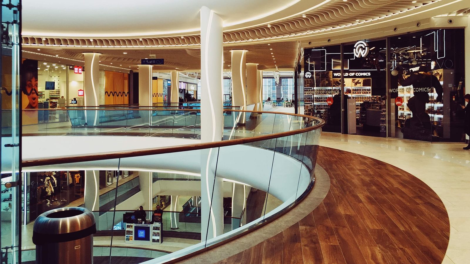 An overview of the walkway of a mall with many shops on the side.