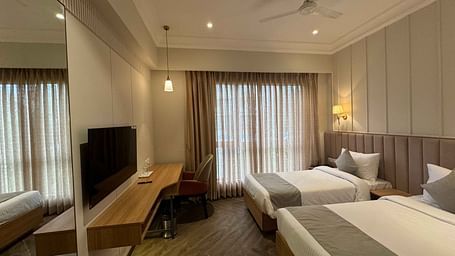 side view of the twin bedroom with a television at  Hotel Mumbai House Mindspace Malad