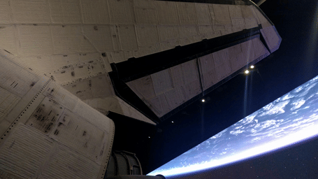 A close-up view of a spacecraft's tiled exterior and wing, set against a black background depicting the edge of space.