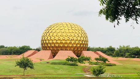 The golden dome in Aurovilla in view with manicured garden surrounding it