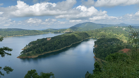 Aerial view of Umiam Lake surrounded by lush green hills near Shillong, Meghalaya.