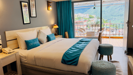 A plush double bed in the Premium Room overlooking the beautiful valley views - The Tattva, Joshimath