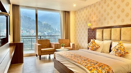 image of the premium room with balcony highlighting a beautiful mountain views from the huge windows - ZENQ SIGNATURE INN, MCLEODGANJ