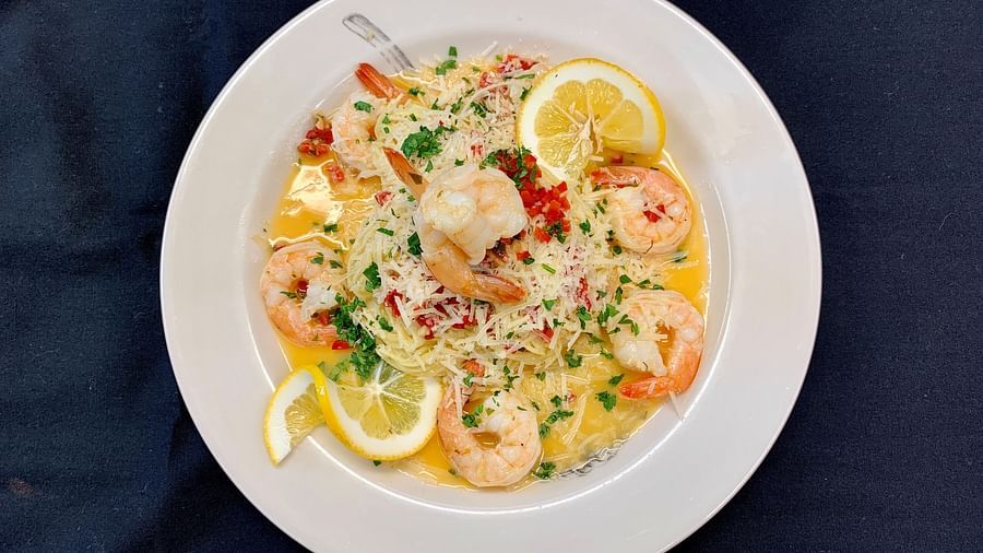 A creamy seafood risotto served on a white plate - Brewery Gulch Inn & Spa