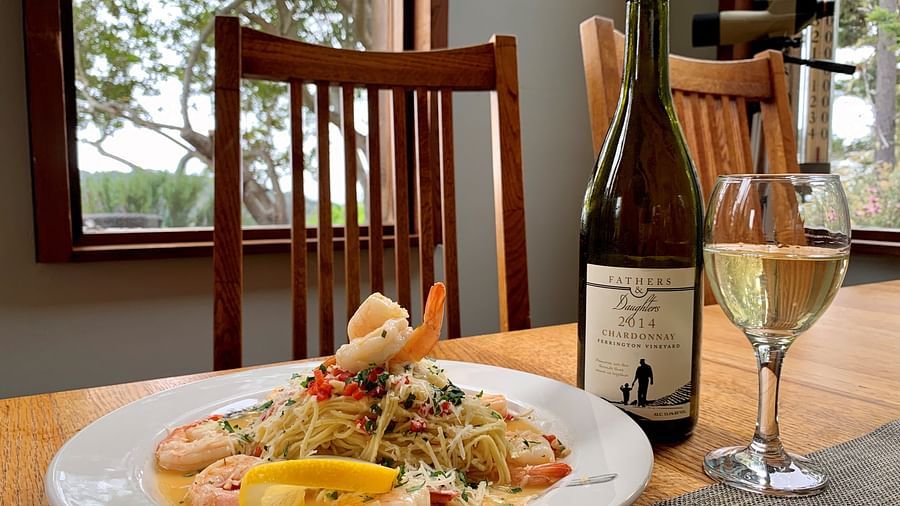 A cozy dinner setup with pasta and a bottle of wine - Brewery Gulch Inn & Spa