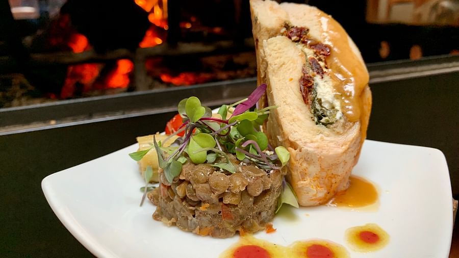 A stuffed pastry dish plated with colorful sauces - Brewery Gulch Inn & Spa