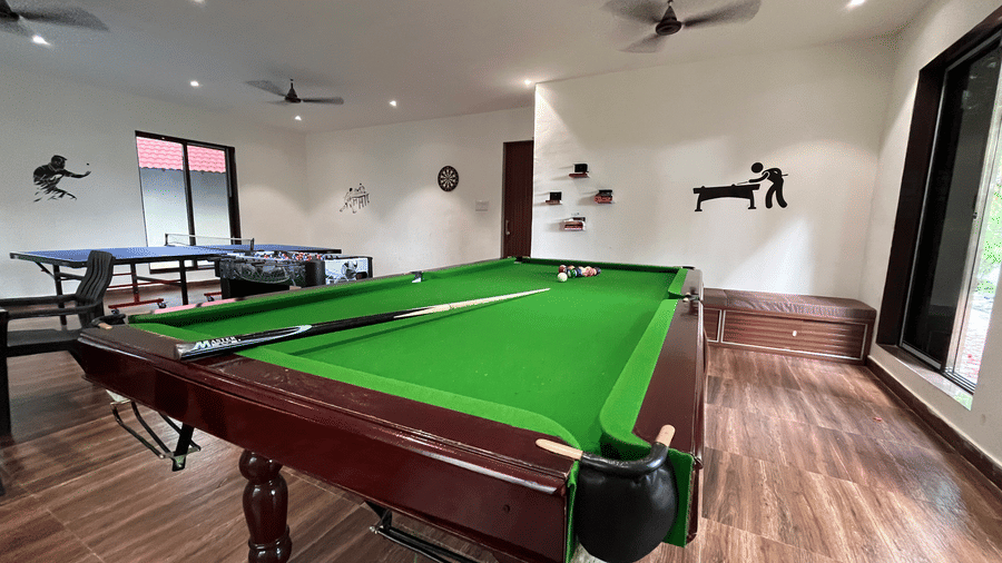 Recreational room featuring a professional green felt billiards table and indoor games - DAN Resorts & Weddings, Palghar