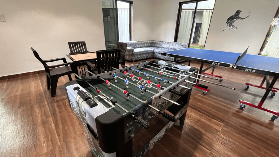 Indoor recreational area featuring a foosball table and table tennis setup - DAN Resorts & Weddings, Palghar