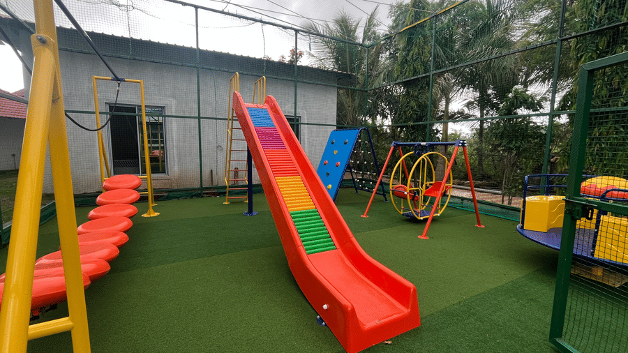 Children's playground with colourful slides at DAN Resorts & Weddings, a family resort near Mumbai.
