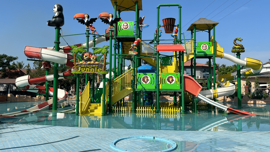 Large colourful water park structure with multiple slides and splash buckets for children - DAN Resorts & Weddings, Palghar