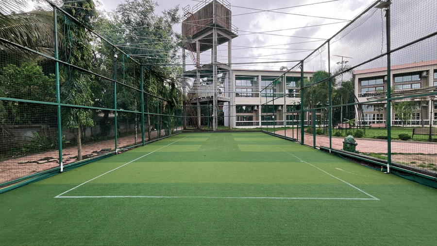 Wide view of the professional artificial turf court for cricket and football - DAN Resorts & Weddings, Palghar
