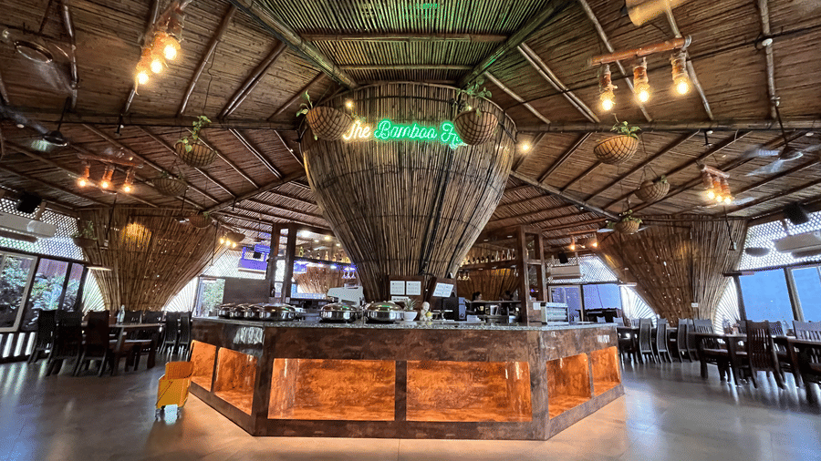Rustic wooden bar counter with a bamboo-style ceiling and warm ambient lighting - DAN Resorts & Weddings, Palghar