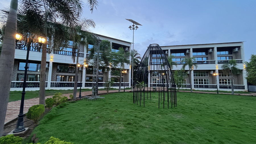 Modern multi-storey resort building with glass balconies and manicured lawns - DAN Resorts & Weddings, Palghar