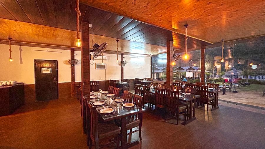 Dining area of the in-house restaurant at DLS MJ River Resort, Rishikesh.