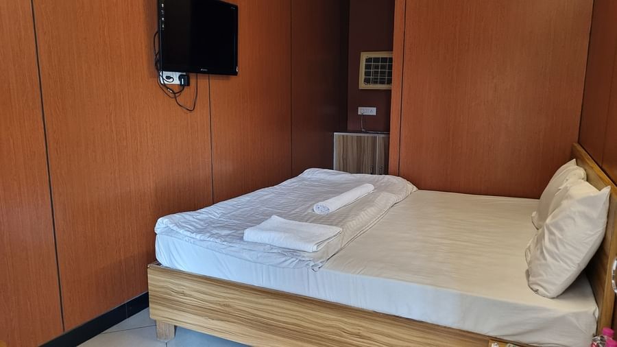 A double bed with pillows and a comforter placed over it at the Dream Vision Guest House.