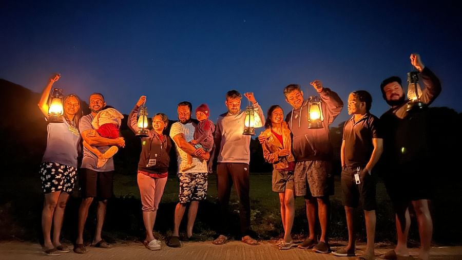 A group holding lanterns and posing for the camera with few of them holding babies - Evergreen County