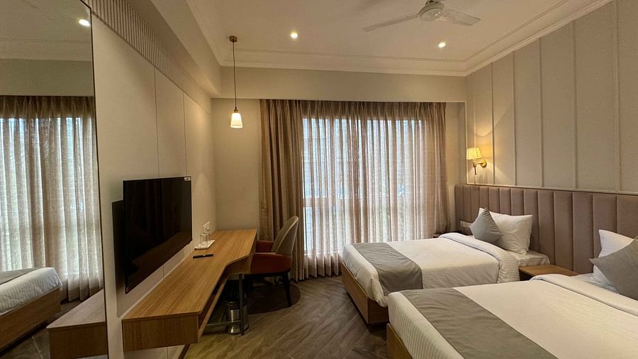 side view of the twin bedroom with a television at  Hotel Mumbai House Mindspace Malad
