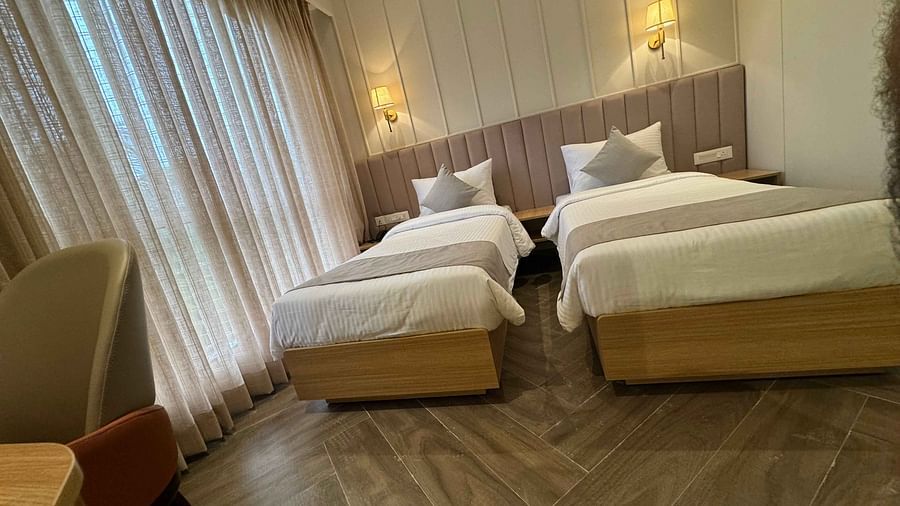 Image of twin bedroom with sheer curtain at  Hotel Mumbai House Mindspace Malad