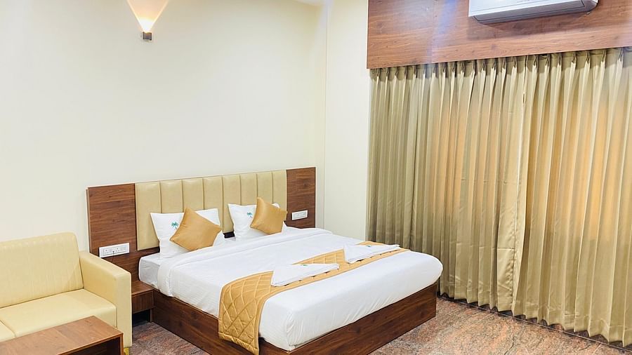 Deluxe room with soft lighting, cosy seating, and neat interiors at Hotel Sahara Tree.