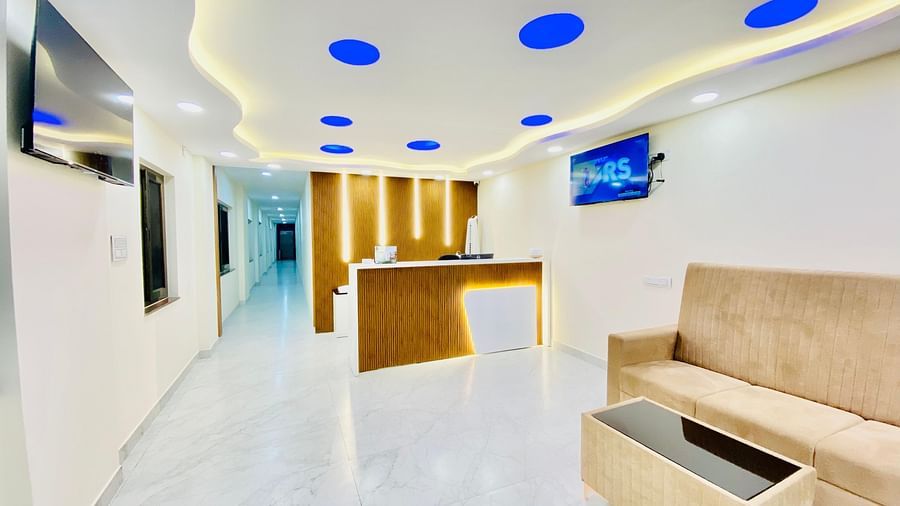 Bright, modern lobby area with white interiors and stylish ceiling lighting at Hotel Sahara Tree.