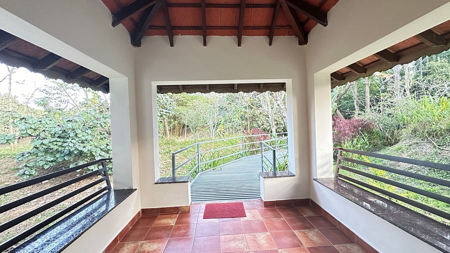 a verandah with views of trees around the property - Kadkani River Resort, Coorg