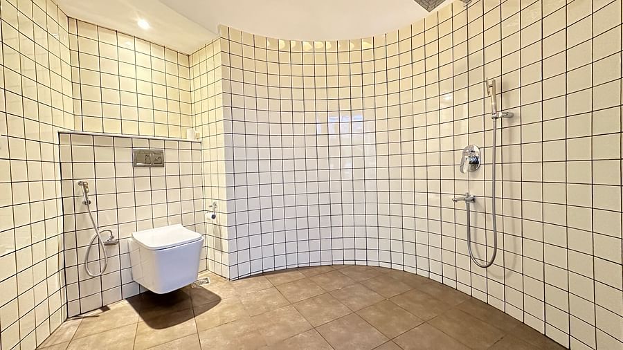 a bathroom with a western style toilet and a shower - Kadkani River Resort, Coorg