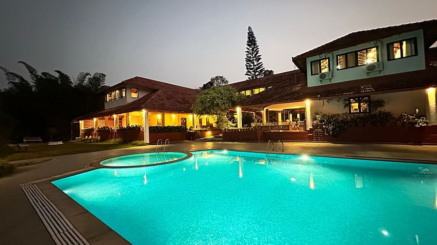 view of a swimming pool with the property in the background - Kadkani River Resort, Coorg