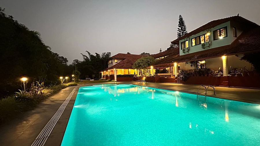view of a swimming pool with the property in the background - Kadkani River Resort, Coorg