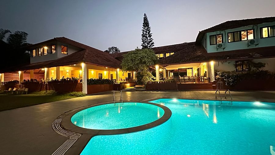 view of a swimming pool with the property in the background - Kadkani River Resort, Coorg