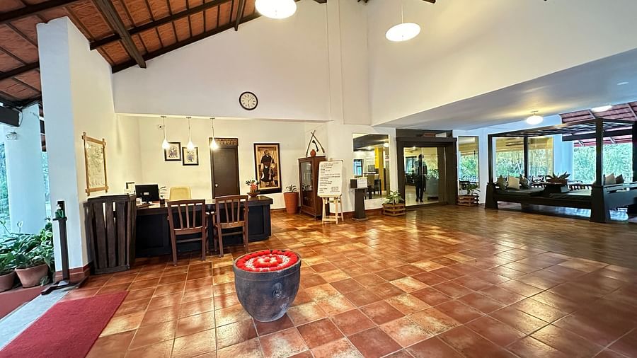 a view of the hotel reception with tables and chairs for lounging - Kadkani River Resort, Coorg