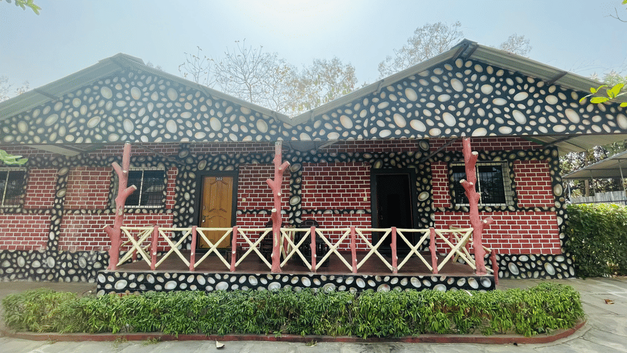 A quaint, pink and black patterned resort with a veranda in a sunny setting - Lighthouse Waterpark & Resort, Nagpur
