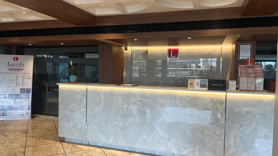 Reception area at Lords Eco Inn Dahej with a sleek front desk and warm lighting.