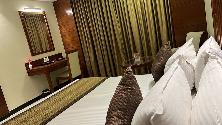 A head top view of the room with bed, work desk and the mirror. 