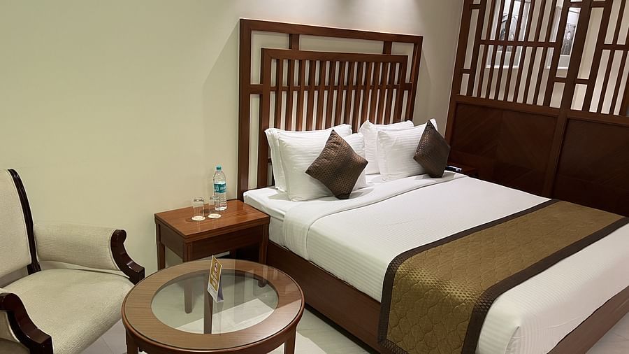 A side angle view of the suite  with a tea table and chair.