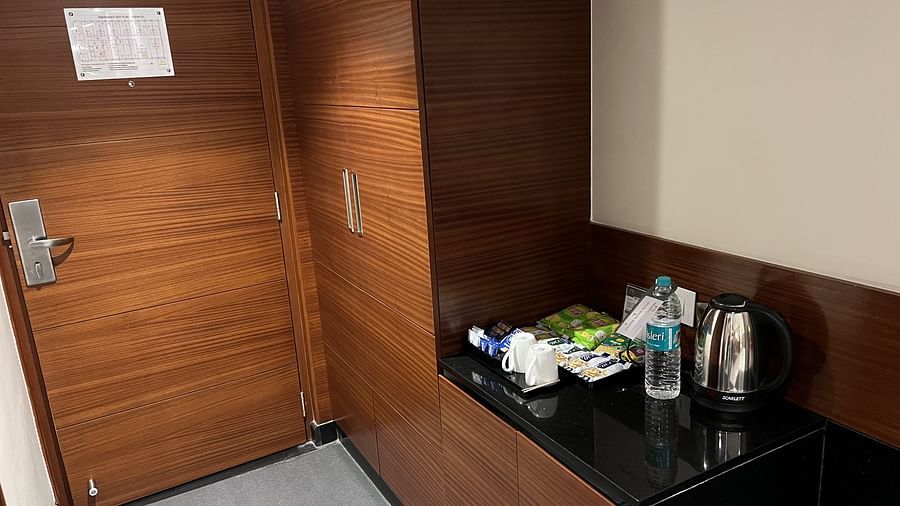 A amenities section area with the kettle, water bottle and other items.